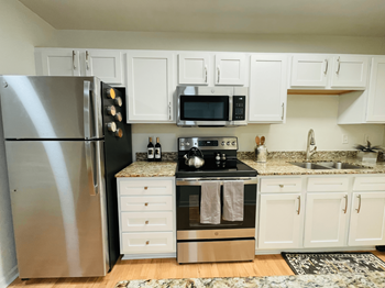 a kitchen with stainless steel appliances and white cabinets